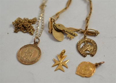 Lot 38 - A 9ct gold St Christopher charm on chain, two charms on a broken chain and a 9ct gold fancy...