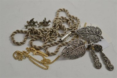 Lot 101 - Two marcasite leaf brooches, stamped 'silver', a 9ct gold cross, marcasite earrings and two chains