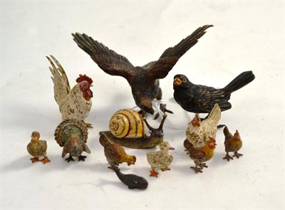 Lot 121 - A collection of cold painted bronzes comprising a snail, a black bird, an eagle, a cockerel, a hen