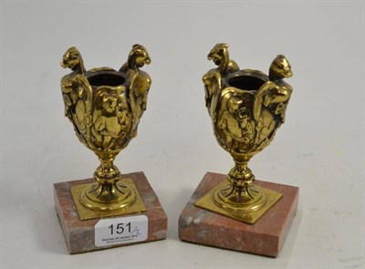 Lot 151 - A pair of gilt metal urn shaped candle holders on marble bases