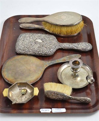 Lot 182 - A silver backed mirror, another, three brushes, a dish and a silver plated chamberstick (7)