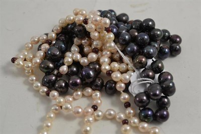 Lot 205 - A strand of cultured pearls with garnet beads and a dyed cultured pearl necklace