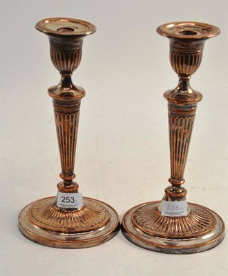 Lot 253 - A pair of silver on copper Regency style candlesticks