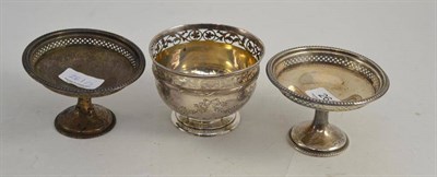 Lot 261 - An Edward VII silver bowl with pierced rim, London 1904 and a pair of silver dishes, Birmingham...