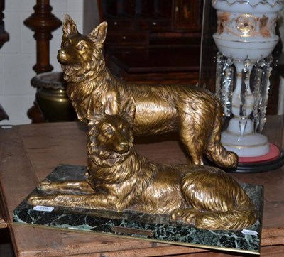 Lot 278 - Gilt metal figure group of two Alsatians on green marble base with label D.H Chiparus