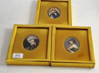 Lot 302 - Three gilt framed portrait miniatures on porcelain, the oval pair after JB Greuze, the other...