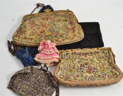 Lot 314 - Two embroidered purses, two beadwork purses, another black purse, a bisque doll