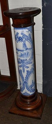 Lot 385 - A blue and white pottery column pedestal with oak base and top, 88cm high
