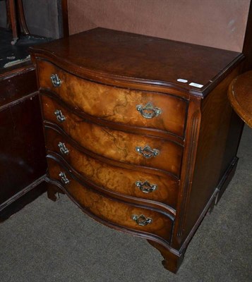 Lot 397 - Reproduction walnut serpentine front four height chest