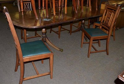 Lot 414 - A set of six mahogany dining chairs with lattice backs and drop in seats and a twin pedestal dining