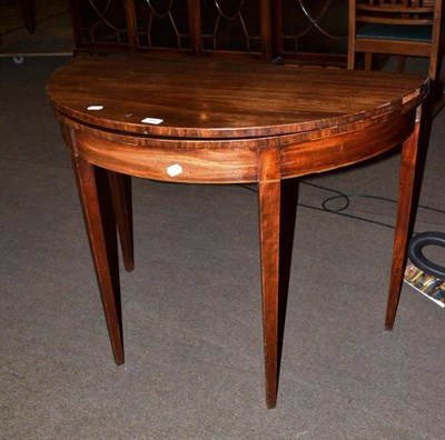 Lot 419 - A mahogany demi-lune fold-over card table