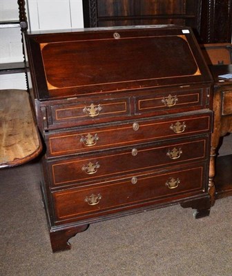 Lot 421 - A George III mahogany bureau with boxwood stringing and well fitted shaped interior with pigeon...