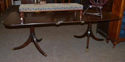 Lot 448 - A mahogany pedestal dining table with brass castors and extra leaf