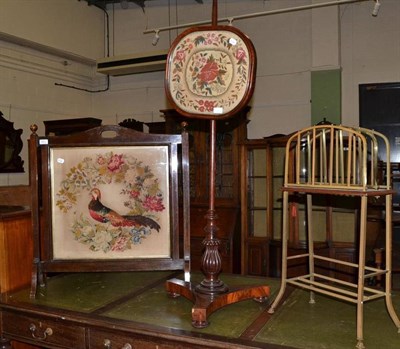 Lot 451 - 19th century mahogany pole screen, fire screen and a brass magazine rack (3)
