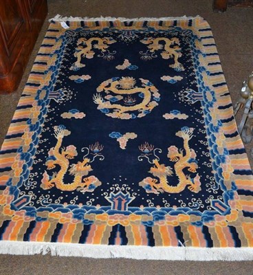 Lot 490 - Chinese dragon rug Ninghsia Province, the deep indigo field centred by a roundel dragon...
