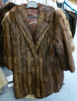 Lot 558 - Black Persian lamb coat with shawl collar, two musquash fur jackets and a faux fur jacket and stole