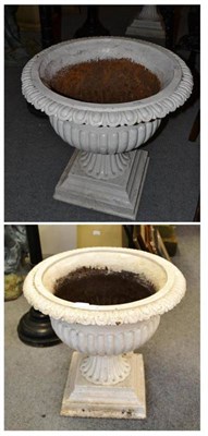 Lot 573 - A pair of cast iron cream painted campana form garden urns
