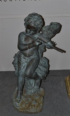 Lot 574 - A patinated metal figure of a cherub playing a flute, possibly copper