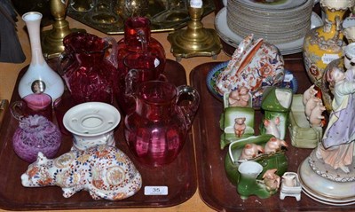 Lot 35 - Two trays of decorative ceramics and glass including cranberry glass jugs, Rudolstadt...