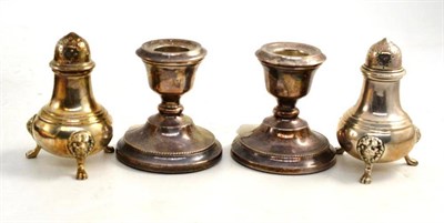 Lot 96 - A pair of silver pepperettes and a pair of dwarf candlesticks