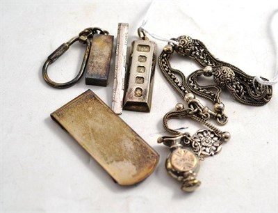 Lot 123 - An Albertina, a silver money clip, a silver ingot, a tie clip and a keyring