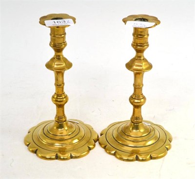 Lot 163 - Late Georgian petal based brass candlesticks