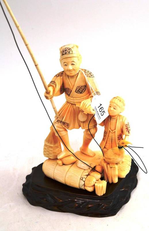 Lot 165 - A Japanese walrus ivory sectional figure of a cormorant fisherman with young helper, circa 1930, on