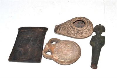 Lot 285 - An Egyptian bronze Shabti, an Egyptian small earthenware tile, a Roman earthenware oil lamp and...