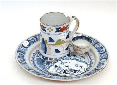 Lot 323 - An 18th century polychrome mug, blue and white Delft charger, an 18th century English blue and...