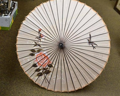 Lot 357 - Burmese parasol with silver handle in metal protective tube
