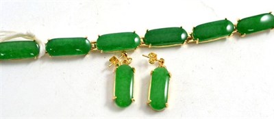 Lot 384 - A jadeite bracelet and a pair of earrings