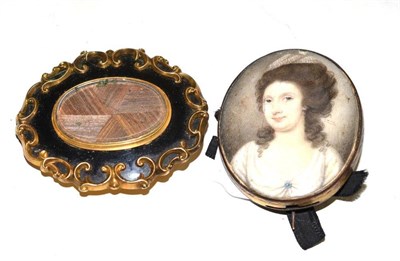 Lot 389 - A late 18th century miniature portrait of a lady on ivory, in a gilt metal brooch setting and a...