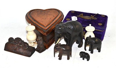 Lot 464 - St Helena 1901 treen heart-shaped box, four ebony elephants and another, wooden bear and lion, pair