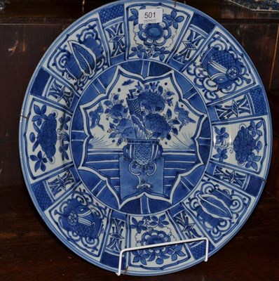 Lot 501 - An Arita porcelain dish, in Kraak style, painted in underglaze blue with a jardinière of foliage