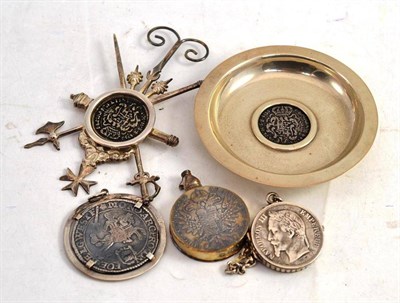 Lot 517 - A coin locket, a coin scent flask, a coin set pendant, a coin set pin dish and a coin set easel...