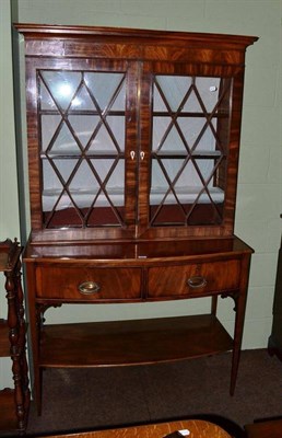 Lot 603 - An early 19th century mahogany glazed cabinet on a later two drawer stand