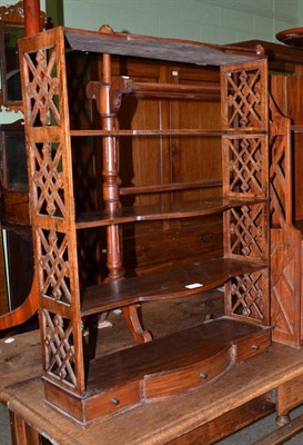 Lot 642 - A mahogany break bow front fret carved wall shelf