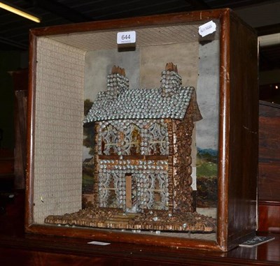 Lot 644 - A Victorian shell decorated model of a house with garden and sides mounted with cork, painted paper