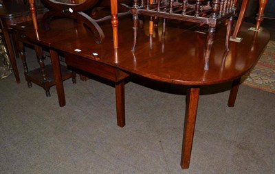 Lot 663 - A 19th century mahogany drop leaf dining table