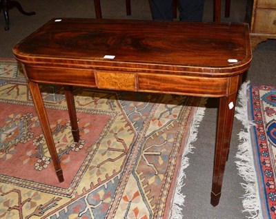 Lot 680 - A late George III mahogany fold over card table