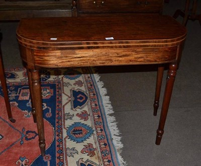 Lot 685 - A late George III mahogany fold over tea table