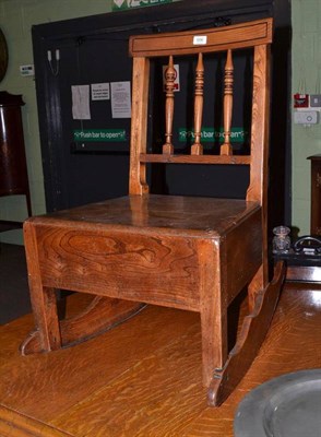 Lot 696 - A provincial elm small rocking chair