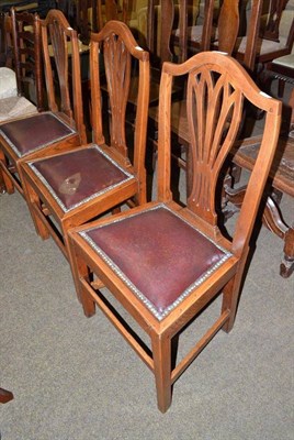 Lot 703 - Three Hepplewhite style dining chairs and a ladder back chair with rush seat