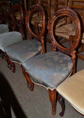 Lot 721 - A pair of Victorian walnut balloon back salon chairs