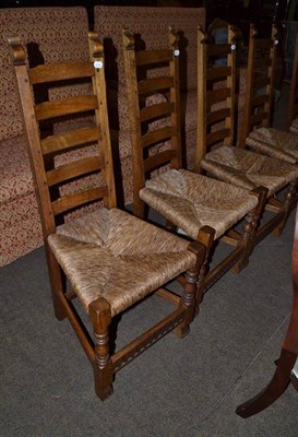 Lot 723 - A set of six oak ladder back chairs with rush seats