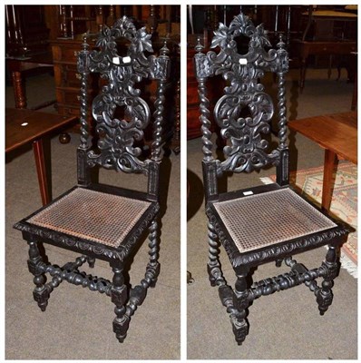 Lot 727 - A pair of Victorian ebonised oak side chairs with cane seat and foliate carved decoration