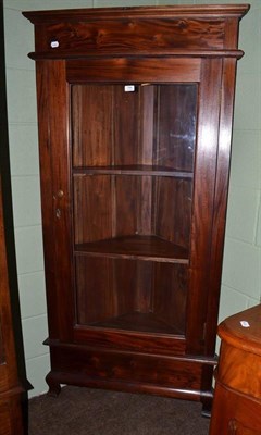 Lot 784 - A reproduction carved hard wood glazed floor standing corner cabinet