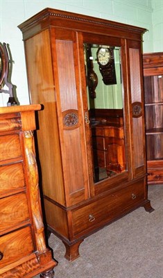 Lot 785 - An early 20th century walnut single mirror door wardrobe