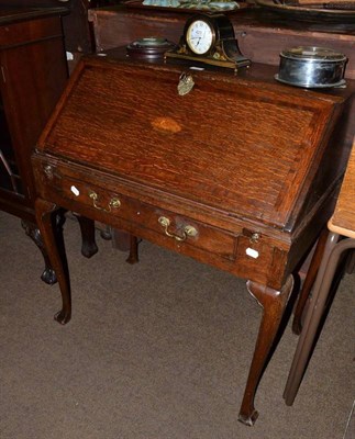 Lot 795 - An 18th century oak small bureau on stand