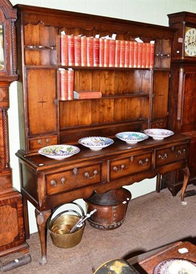 Lot 801 - A Georgian style oak dresser and rack on cabriole legs